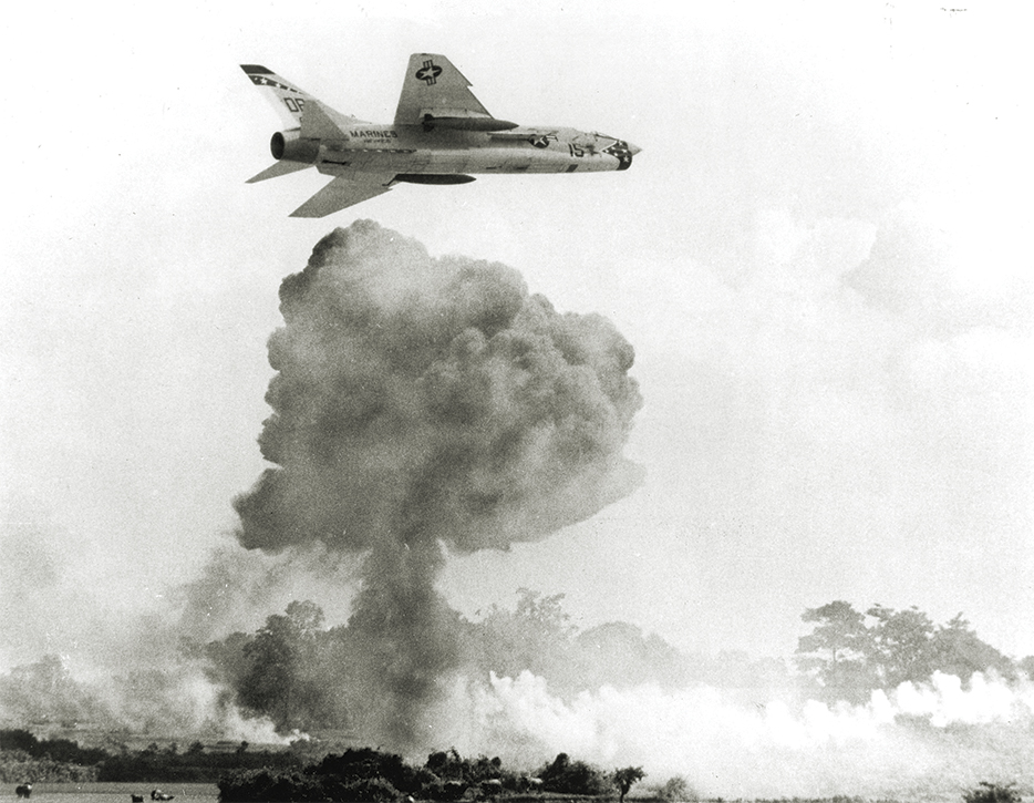 Photo of, Responding to reports of Viet Cong mortar attacks on two landing zones in 1966, a Vought F-8E Crusader of U.S. Marine fighter (all-weather) squadron VMF (AW)-312 unloads on a target after its element leader dropped its bombs.