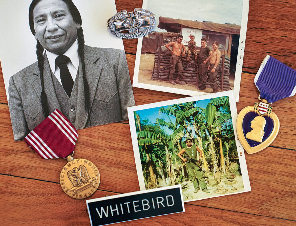 Photo of Whitebird’s trove of wartime memorabilia includes a photo of him in fatigues, another with fellow medics and a local boy, a Good Conduct Medal and his hard-earned Purple Heart and Combat Medical Badge. After the war he attended Harvard but also regrew his Lakota braids.