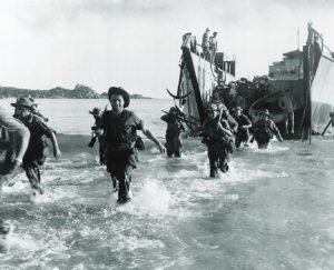 Photo of Marine commando forces of the French Expeditionary Corps wading ashore from a landing craft, in the Annam region in central Vietnam, as war operations against the Communist Viet Minh continue, on July 27, 1950.