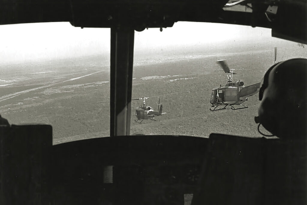 Photo of Hueys of the 155th Assault Helicopter Company transport SOG reconnaissance troopers to an area near the Cambodian border.