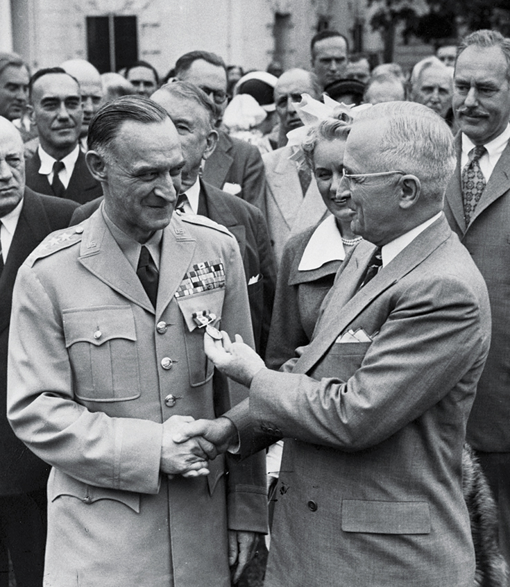 Photo of President Harry S. Truman awarding American General Lucius Clay with the Distinguished Service Medal for his role in the Berlin Airlift.