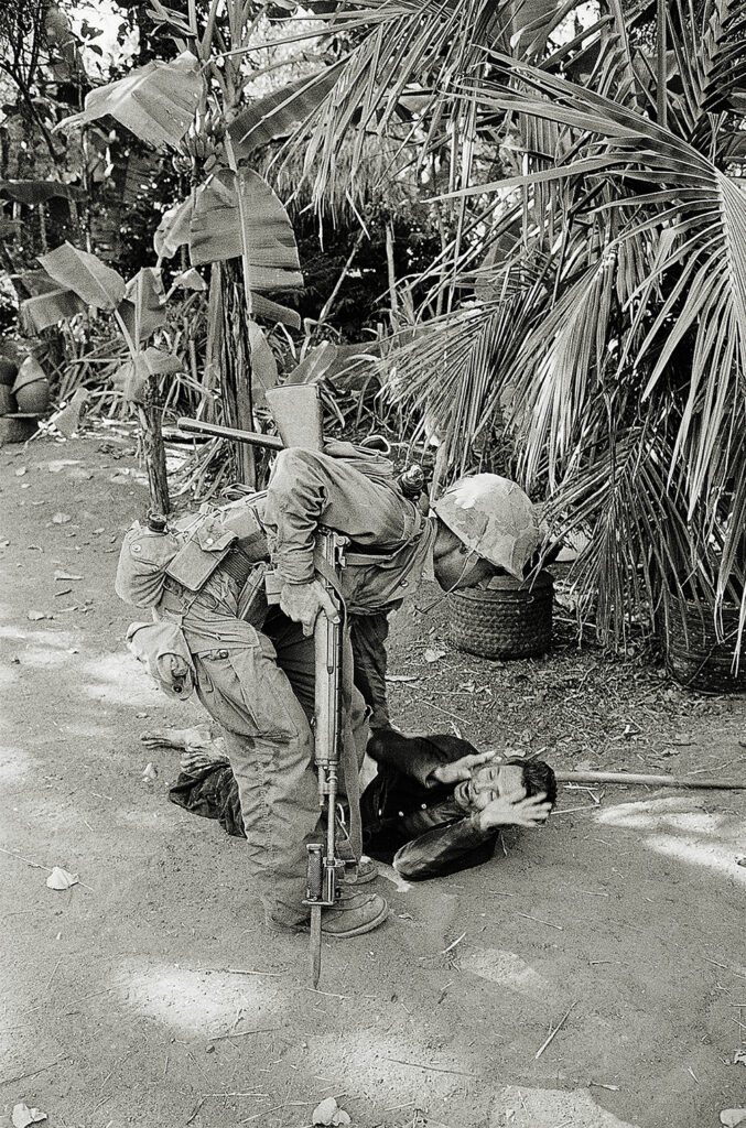 Photo of a Viet Cong suspect pleading for his life as a US Marine stands over him with his bayonet pointed to the ground during mopping-up operation following a major American victory over the Communists at Van Tuong Peninsula, south of Chu Lai. Marines killed more than 500 Viet Cong soldiers in a 2-day, land-sea pincers operation against an enemy force estimated at 2,000 men.