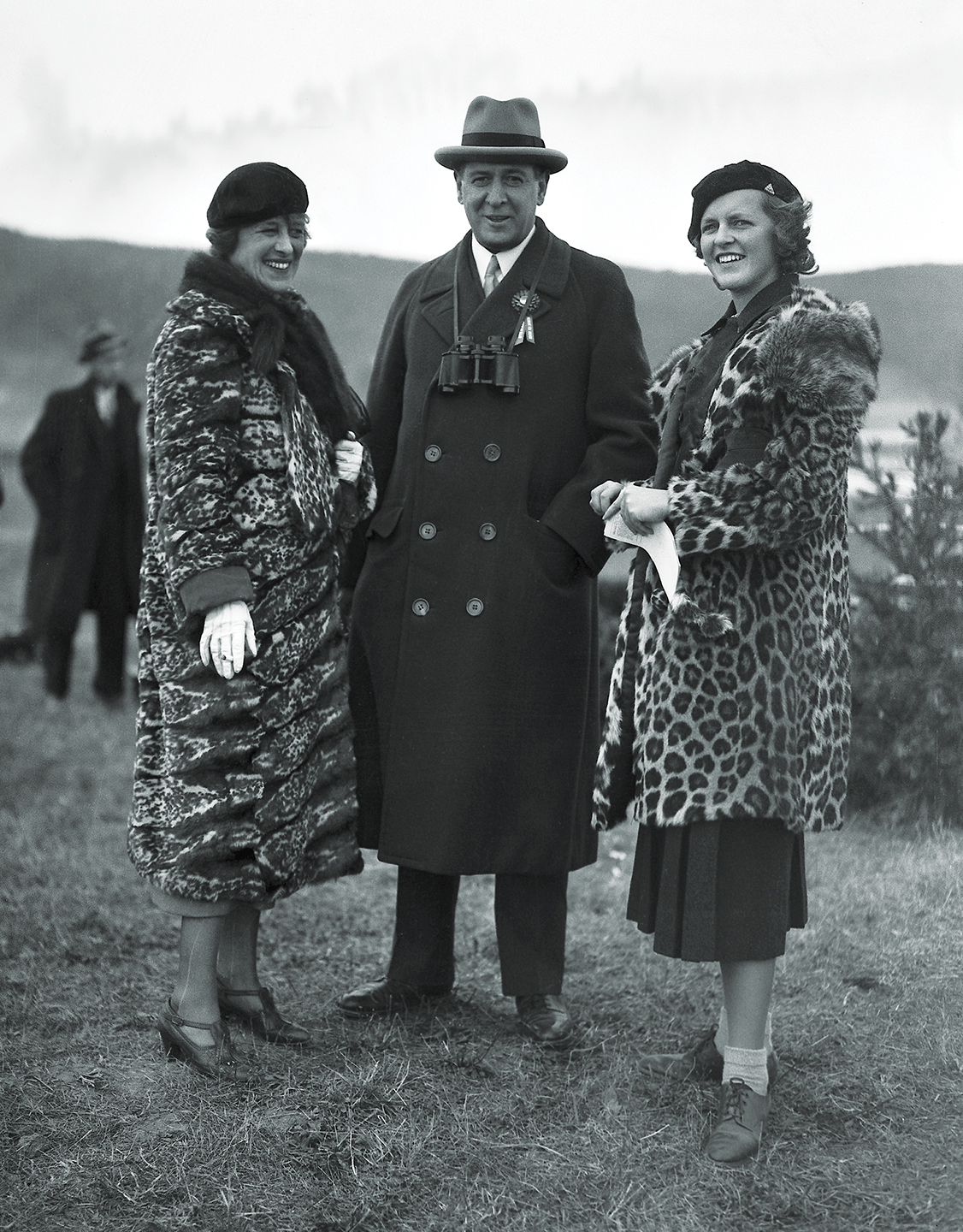 Photo of American financier and president of the New York Stock Exchange Richard Whitney poses with his wife Gertrude (nee Sheldon Sands) and his daughter Nancy at an unidentified event, 1934.