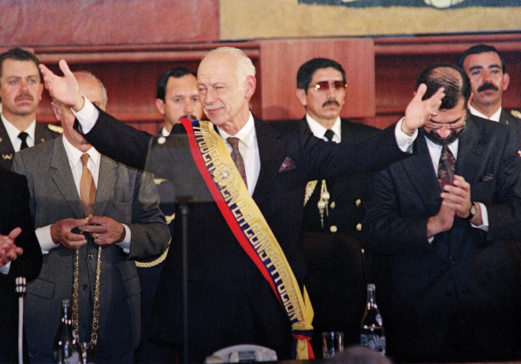 Photo of Ecuadorian President Sixto Duran-Ballen acknowledges the crowd inside the Congress building in Quito, moments after being sworn-in as the new President of Ecuador on Auguste 10 , 1992. The Presidents from Argentina, Peru, Chile and Colombia as well as other high officials from other countries attended the ceremony.