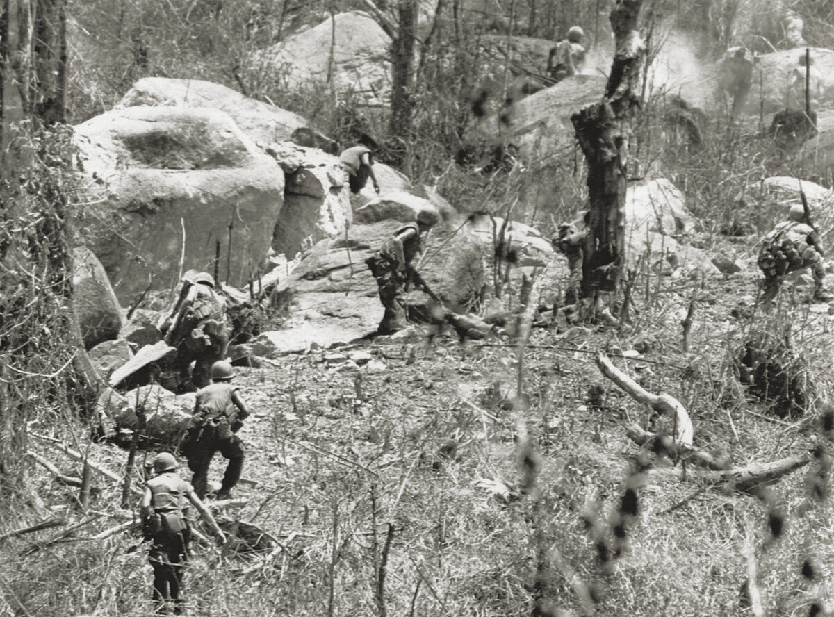 Photo of U.S. Marines are being fired upon as they charge entrenched troops of North Vietnam’s 2nd division on hill 441, near Hiep Duc Valley, South Vietnam on August 26, 1969.