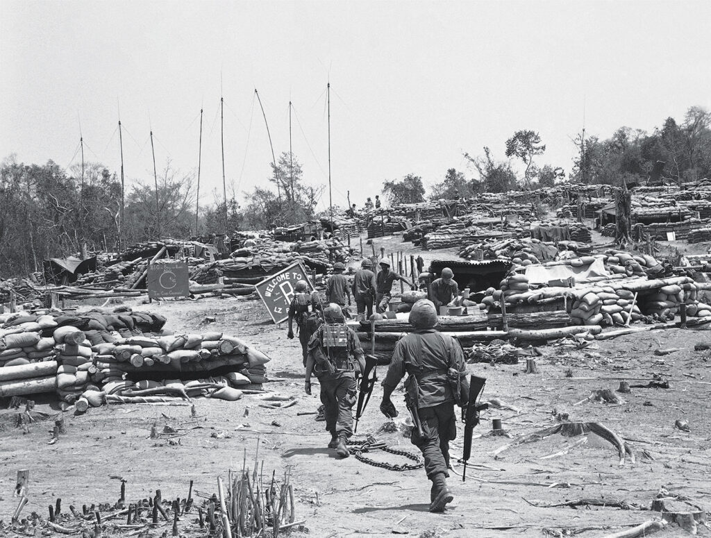Photo of Sandbags, bunkers and logs are every where as protection against Vietcong mortar attacks near Cambodian border in the central Vietnamese highlands, March 24, 1967. The U.S. base, some 265 miles northwest of Saigon, has been under mortar attack 15 times in five days. The 1st Battalion, 22nd Infantry of the U.S. 4th Infantry division protects the area.