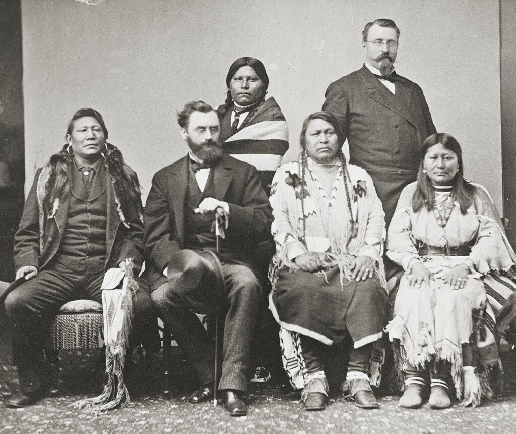 Photo of, During his term as Secretary of the Interior, Schurz, had numerous meetings with Native Americans. Here, front row, he poses with Ute Indians in 1880.