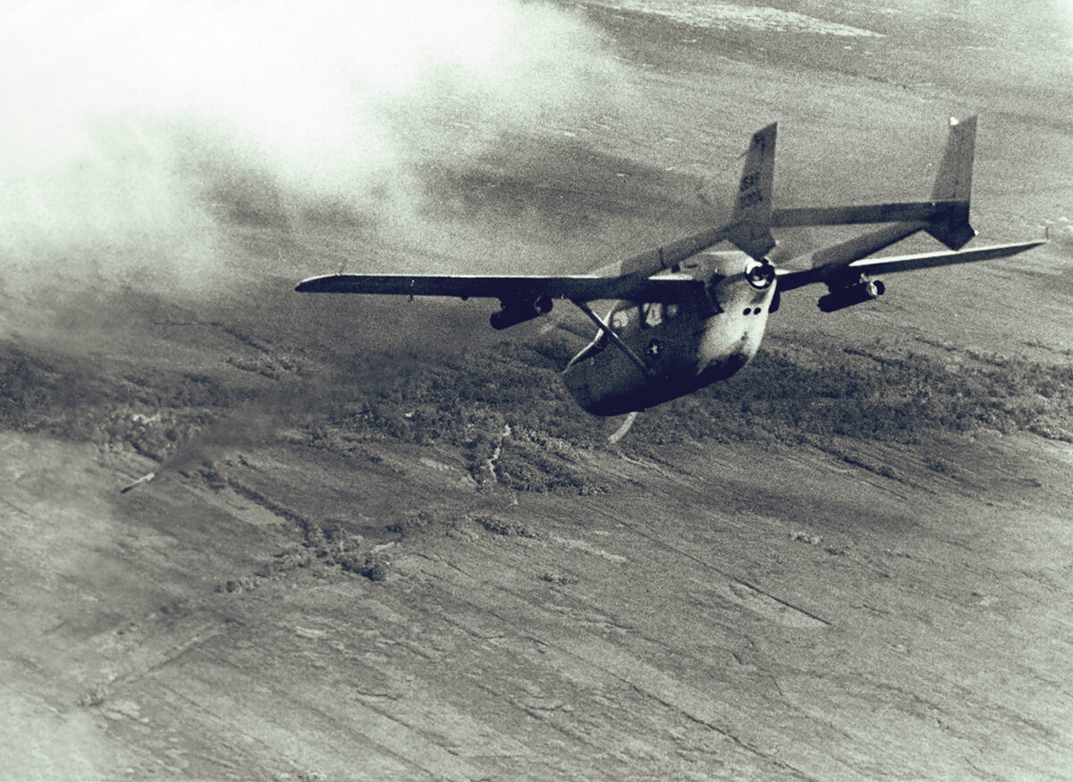 Photo of a O-2A Super Skymaster, used as a FAC aircraft, fires a smoke rocket at an enemy stronghold. The smoke rocket will mark the area for strike aircraft. Fast reaction time and increased time over target, plus the safety factor of its two engines make the O-2 ideal for both psychological warfare and FAC missions.