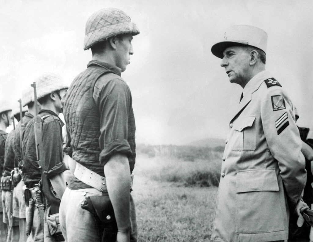 Photo of General Jean de Lattre de Tassigny (1889-1952) reviewing French forces at Hoa Binh, c. 1951.