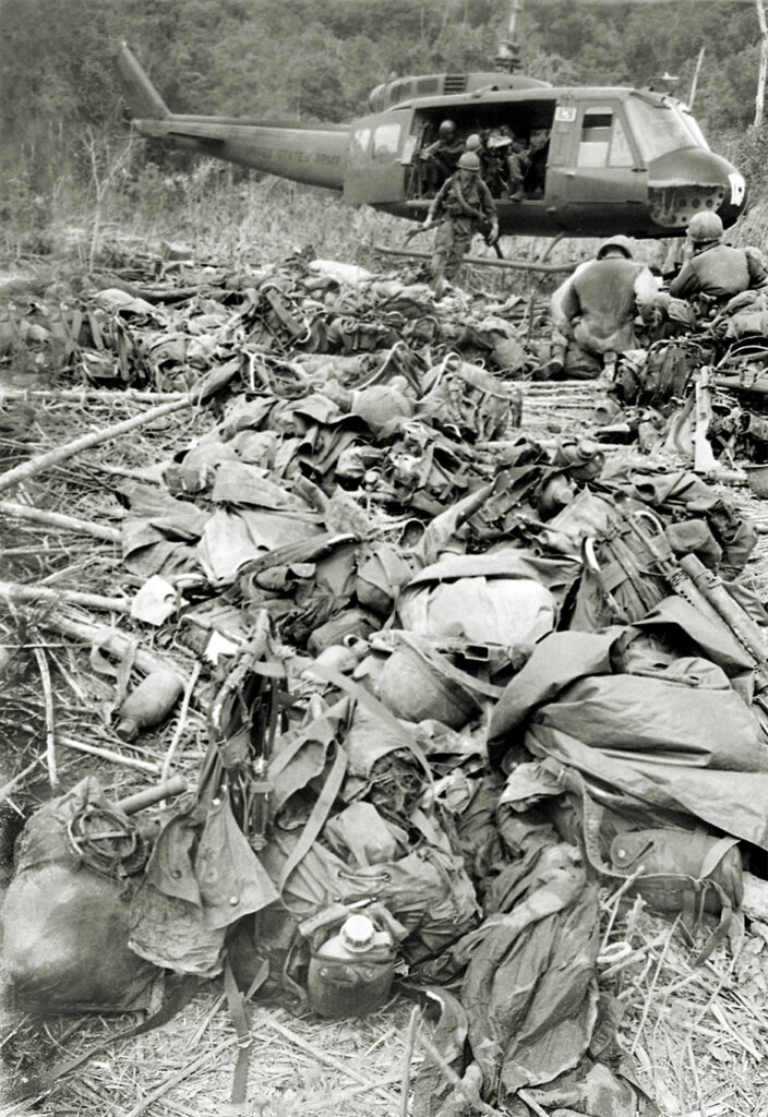Photo of Personal gear, packs, steel helmets and other military gear are collected in a narrow landing zone near the Cambodian border in the central Vietnamese highlands on May 24, 1967, after 95 American casualties - 16 dead and 79 wounded - were evacuated. The casualties were sustained by one company of the 4th division that was attacked by some 600 North Vietnamese with rockets, mortars and then infantry assault on May 22. The company was saved from annihilation by air strikes and artillery. Holding its ground they found 61 North Vietnamese dead and some wounded left behind around their perimeter.