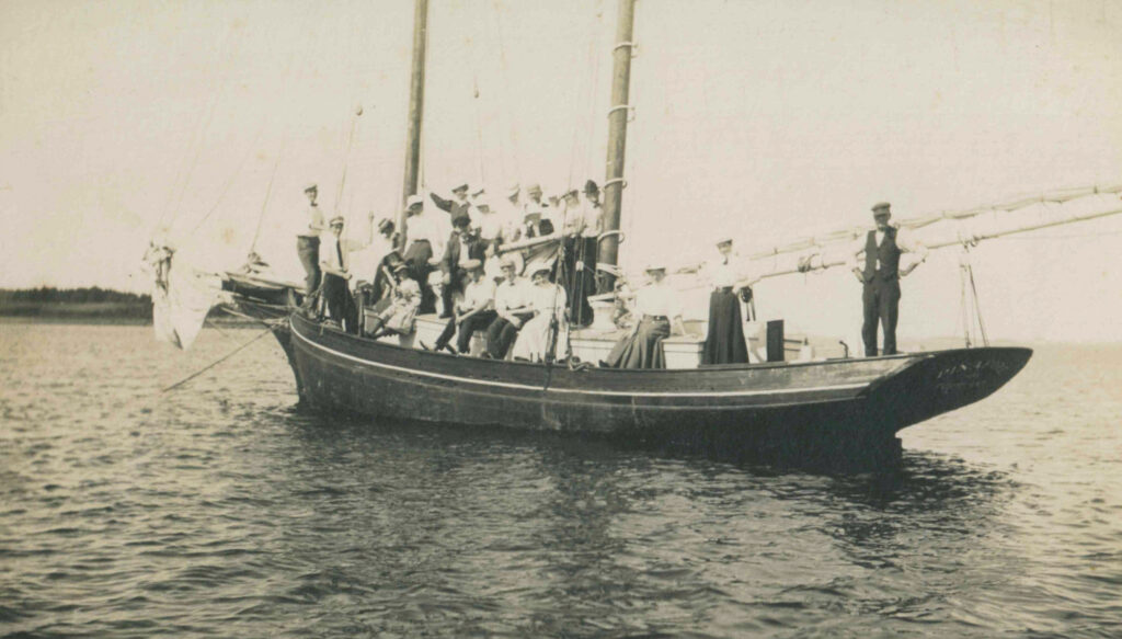 Yacht "Pinafore" with people standing on deck