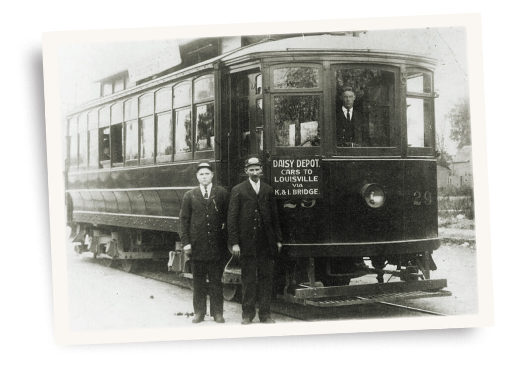 Photo of workers posing with their electric streetcar in New Albany, Ind., 1920.