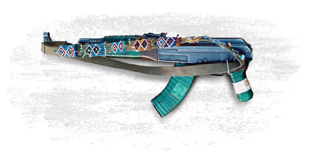 A photo of a AK-47 with a sling bearing tribal needlework speaks to the age-old nature of warfare in Afghanistan.