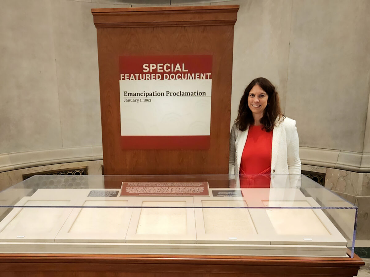 Dr. Colleen Shogan behind display case