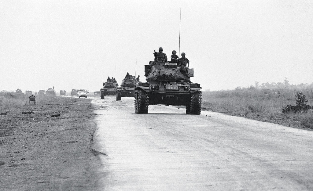 Photo of South Vietnamese tanks moving up Route 13, 40 miles north of Saigon, toward besieged province capital of An Loc, 20 miles further north, April 9, 1972. Tanks and airborne troops are securing the road for reinforcements and airborne troops are securing road for reinforcements and supplies.