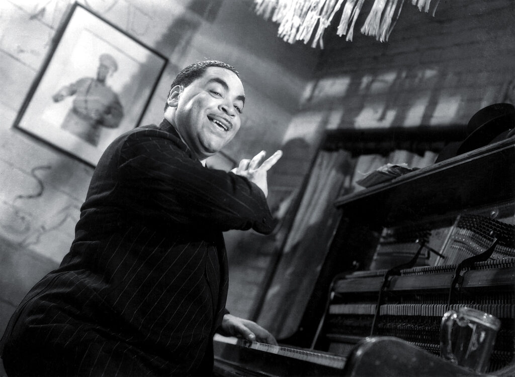 Photo of Thomas "Fats" Waller at a piano.