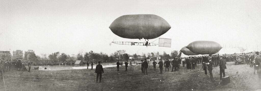 Photo of Captain Tom Baldwin in flight on his balloon the "New California Arrow" during the dirigible races at the International Aeronautic Tournament in Forest Park, 23 October 1907. Photograph by Harry Dudley, 1907.