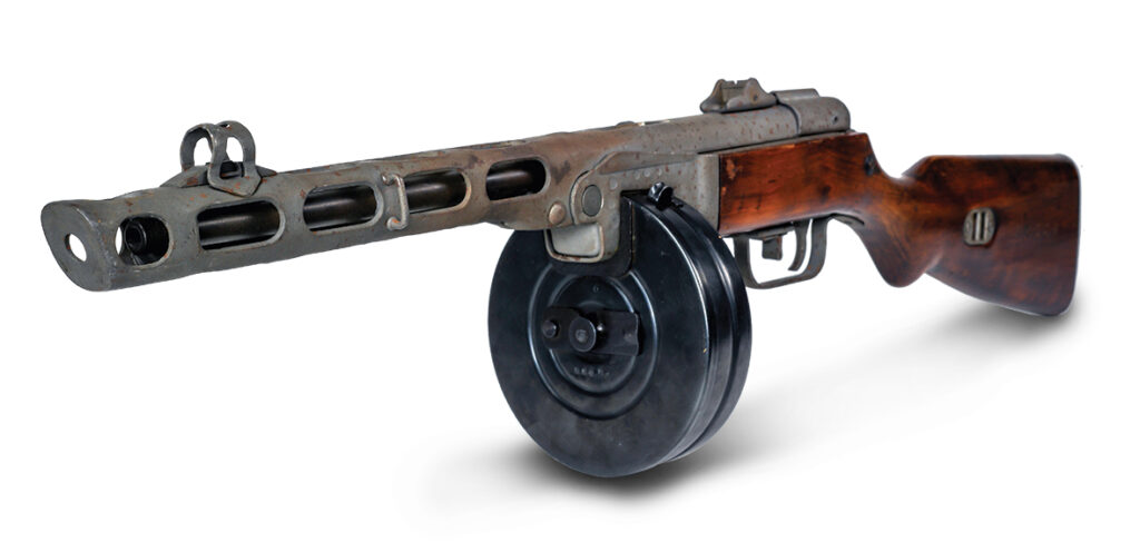 Photo of submachine gun ppsh-41 on a light background. View front left. While Soviet-made PPSh-41 “burp guns” were formidable, they were no match for artillery.