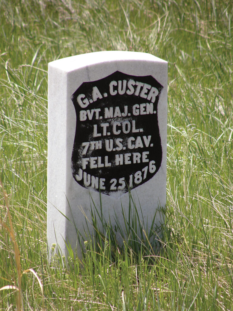 A photo of a marble marker stands where Lt. Col. George Armstrong Custer fell on June 25, 1876, at the Battle of the Little Bighorn.