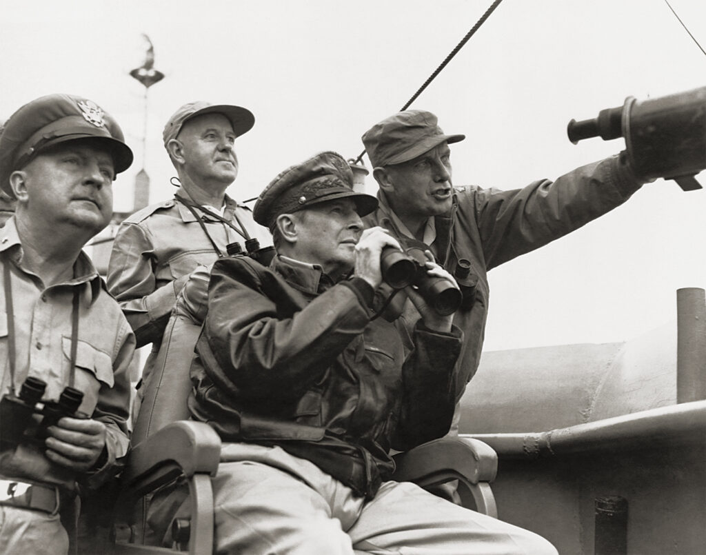Photo of General Douglas MacArthur, General Whitney, and General Almond observe the progress of shelling the enemy before the landing at Inchon. | Location: Near North Korea.
