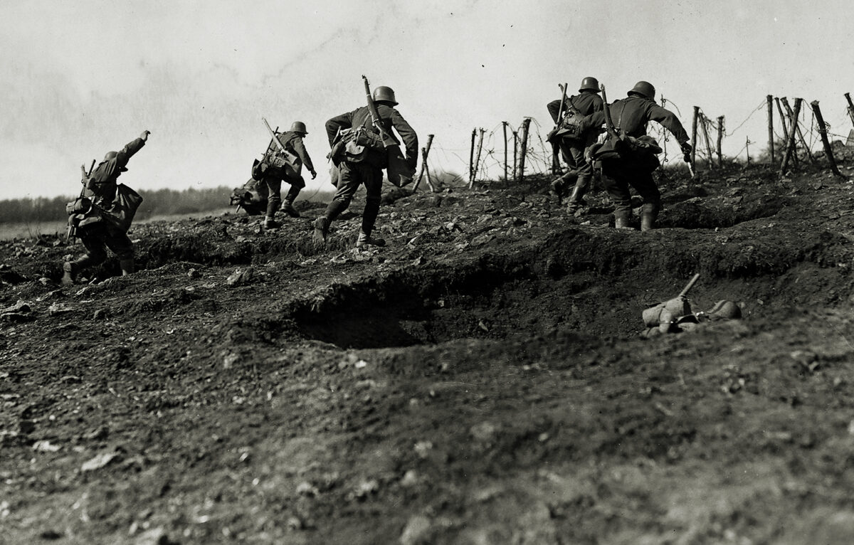 Photo of German storm troops laden with equipment have to advance over open but broken ground. The enemy know of their approach because of a preliminary barrage.