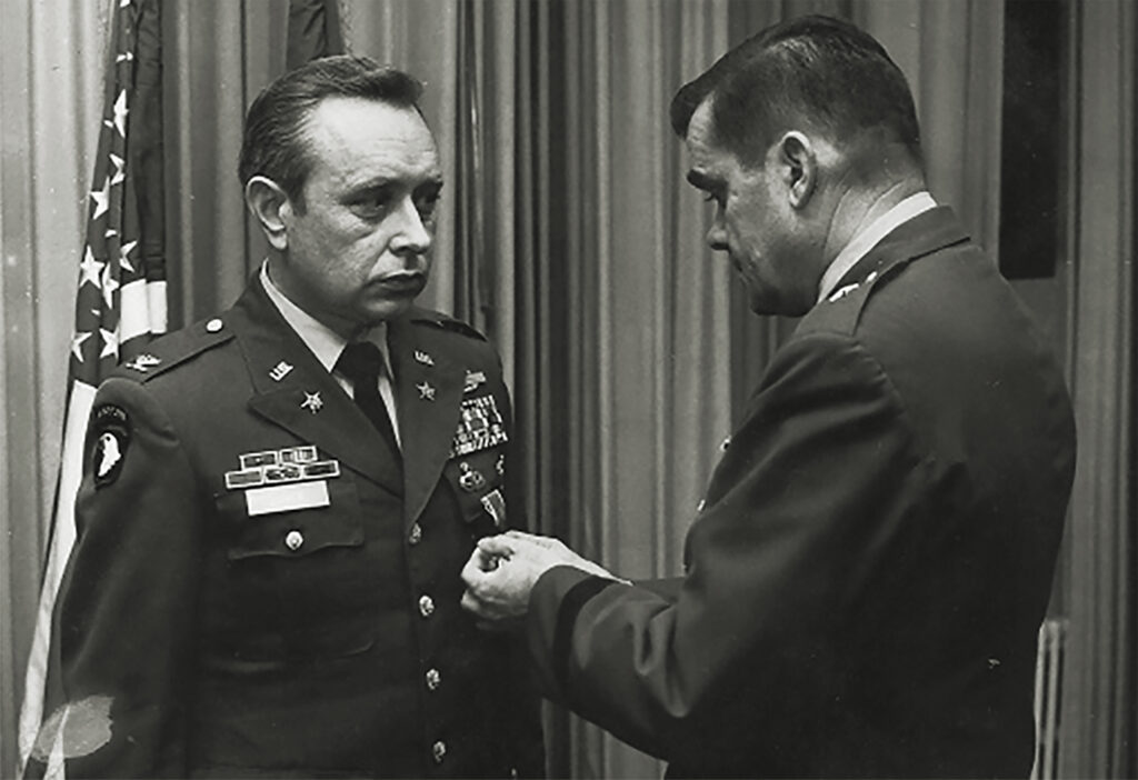 Photo of Henrik O. Lunde, left, receiving the Legion of Merit from Brig. Gen. Robert L. Schweitzer at SHAPE on June 15, 1979.