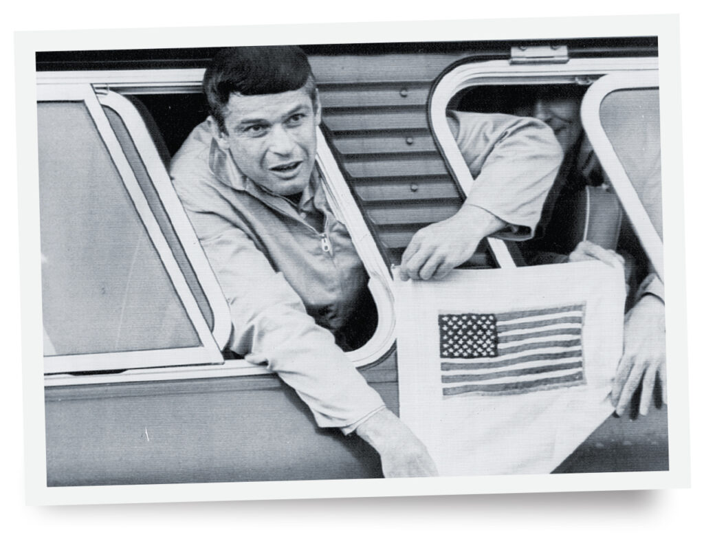Photo of U.S. Air Force captain John Dramesi was one of the leaders of the 1972 plan to escape the Hanoi Hilton. He is shown here after his eventual March 1973 release with the handcrafted American flag he made in captivity.