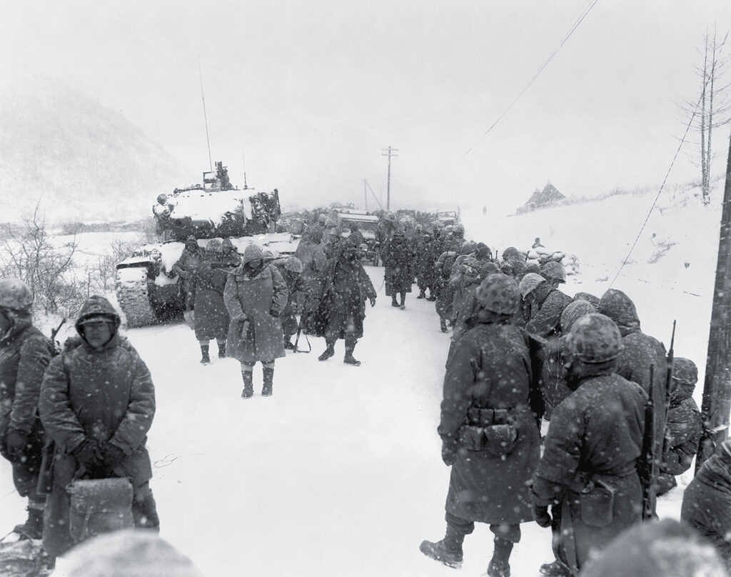 Photo of First Marine Division takes to the road on withdrawal from Koto-ri, south of the Chosin Reservoir.