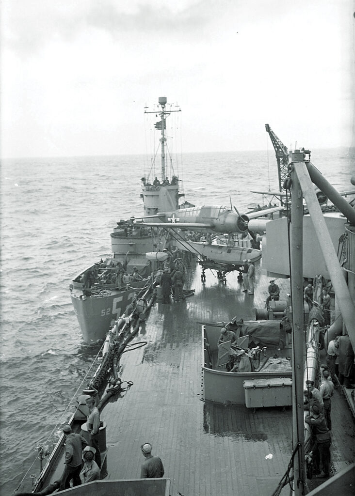 Photo of The Mighty Midgets faced the risk of attack as well as damage from larger ships. LCS-52 takes aboard ammo from the battleship Nevada.