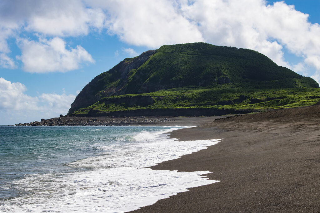 Photo of Mt. Suribachi is visible from the volcanic ash beaches at Iwo To, Japan, May 31, 2022. Mt. Suribachi is the island's most prominent feature and was the site of the famous U.S. Marine Corps flag raising on February 23, 1945. Marines with III Marine Expeditionary Force traveled to Iwo To for a professional military education where they learned about the Battle of Iwo Jima. (U.S. Marine Corps photo by Lance Cpl. Tyler Andrews)