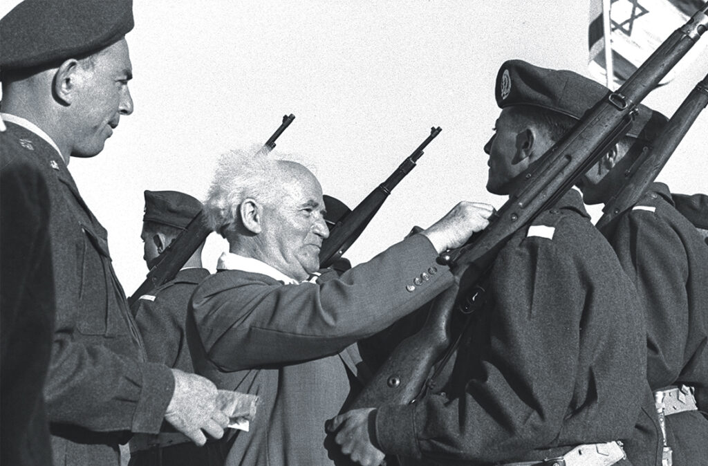 Photo of Prime Minister Ben-Gurion pins badges on graduates of a 1952 IDF officer training course. Though Marcus didn’t live to see either Israel’s birth or the fruition of his own efforts to modernize its military, his legacy lives on in the present-day Israel Defense Forces.