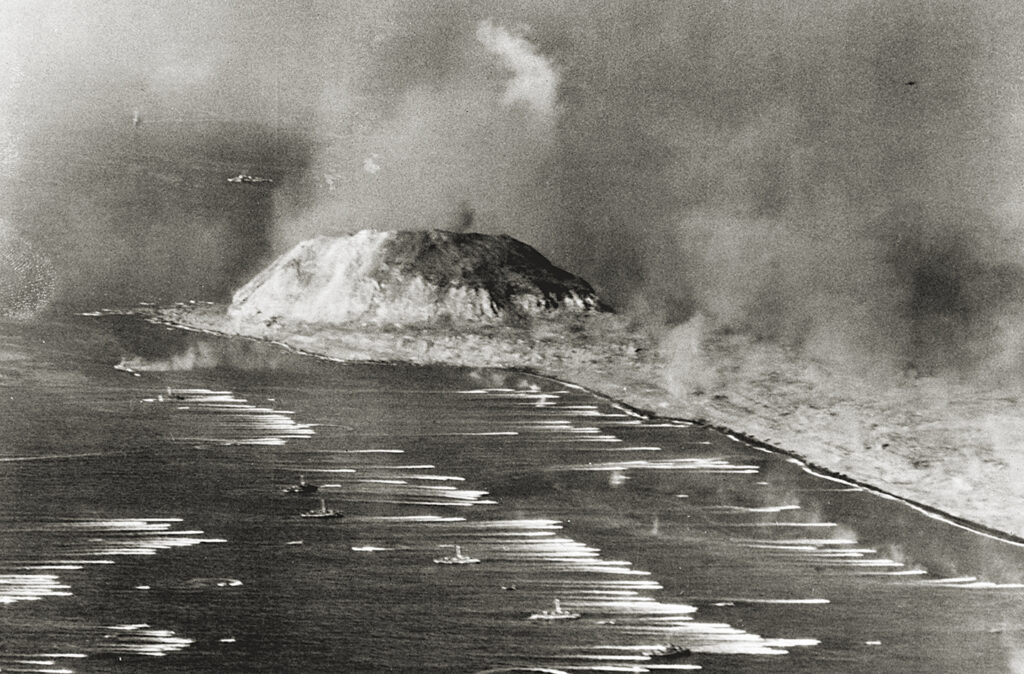 Photo of 10/13/1945-Pacific: This photo, selected as one of the best pictures of the war taken by Navy, Marine corps, and coast Guard photographers, shows Marines in landing craft as they hit the beach at Iwo Jima on Febuary 19, 1945. At left is Mt. Suribachi. This aerial photo was flown to Guam, transmitted by radio, and appeared in U.S. papers within 15 hours after it was made.