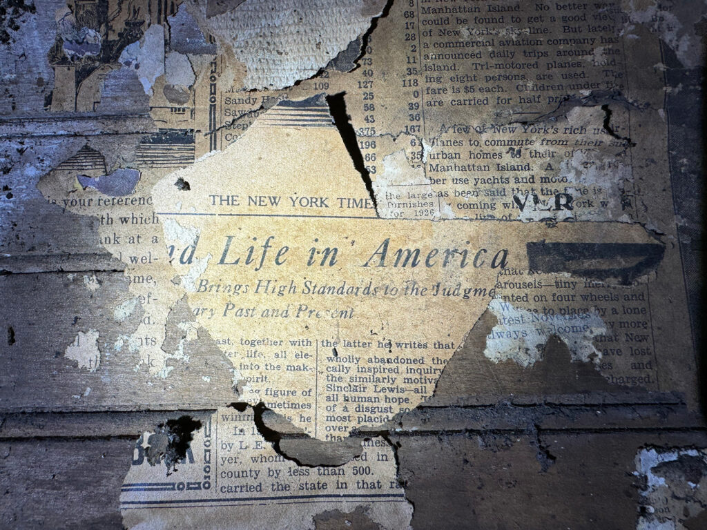 Newspaper clipping affixed to wall