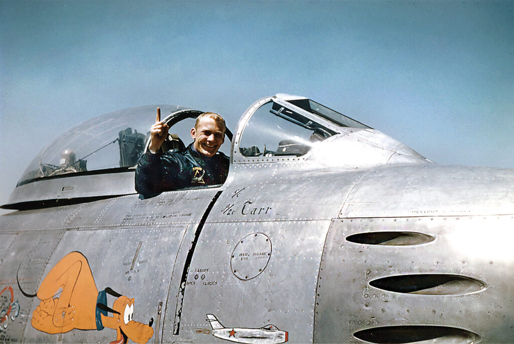 Photo of Second Lt. Aldrin poses in his F-86 Sabre jet fighter in 1953. That May 14 he shot down his first of two North Korean MiG-15s, forcing its pilot to eject.