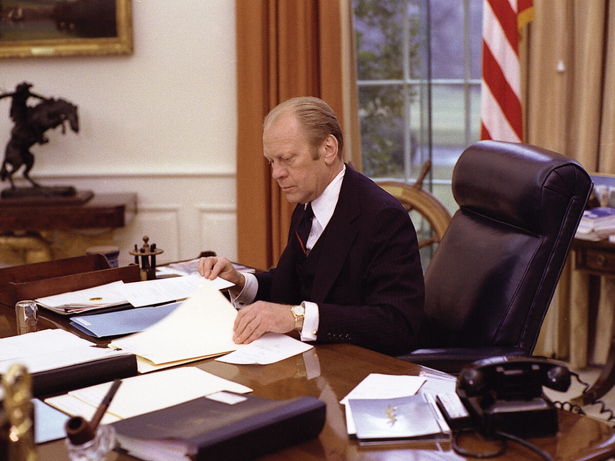 Photo of Gerald Ford at work in the Oval Office in January 1976.