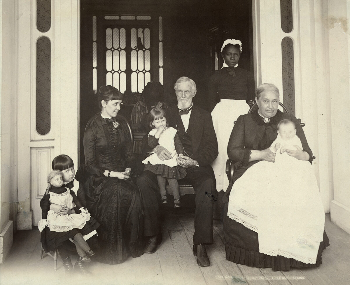 Photo shows the Davis Family at Beauvoir, Mississippi, in 1884 or 1885 (l to r): Varina Howell Davis Hayes [Webb] (1878-1934), Margaret Davis Hayes, Lucy White Hayes [Young] (1882-1966), Jefferson Davis, unidentified servant, Varina Howell Davis, and Jefferson Davis Hayes (1884-1975), whose name was legally changed to Jefferson Hayes-Davis in 1890.