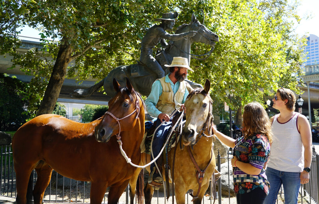 In front of a bronze statue of a Pony Express rider at the Old Sacramento waterfront