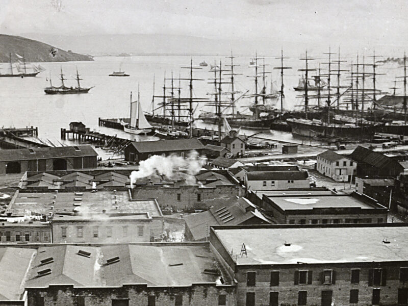 Photo of a crowded harbor scene with buildings and ships docked in slips or sailing around the harbor. San Francisco harbor from Telegraph Hill, Calif.
