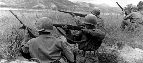 Soldiers of the U.S. Army 5th Regimental Combat Team engage North Korean troops along the Naktong River in 1950. (National Archives)