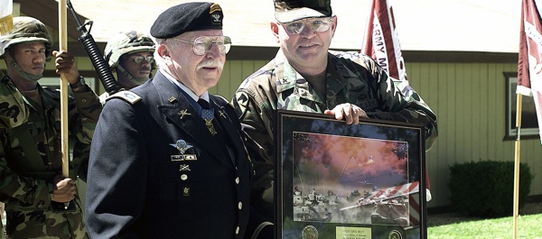 Medal of Honor recipient Col. Lewis Millet, USA, (Ret) a veteran of WWII, the Korean and Vietnam wars, receives a commemorative photograph from Brig. Gen. James D. Thurman during the US Army’s 226th Birthday Celebration at Fort Irwin, CA. (DoD photo)