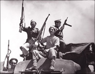 GUNS UP: Members of Haganah celebrate breaking the Arab forces’ blockade of Jerusalem, a success in April 1948 that helped to swiftly shift the momentum of the civil war toward Jewish forces. Photograph: AFP/Getty Images