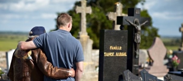 World War II vet Homer Goodman and college student Blake de Hann at a cemetery in Graignes, Normandy, France.