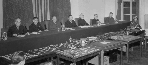 A glittering array of evidence appears before the court-martial board in Frankfurt, Germany, where the three officers were tried in 1946. (National Archives)