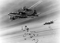 Boeing B-29s drop bombs over Rangoon, Burma.  "Bombshell" originally referred to the physical devastation caused by falling bombs (U.S. Air Force Photo).