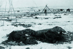 Weeks after Wounded Knee, the bodies of Lakota Sioux lie in the snow wrapped in blankets (Photo: Library of Congress).