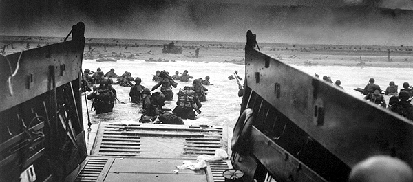 American soldiers wade toward the beach under fire at Normandy, France, on June 6, 1944. (National Archives)