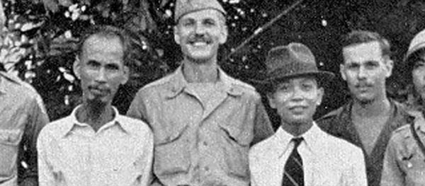 In 1945, translator Henry Prunier (far right) and Major Allison Thomas (center) got to know aspiring nationalist leaders Ho Chi Minh (left) and Vo Nguyen Giap (in suit) better than any American before or since. (Photo courtesy of David Thomas)