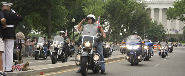 Riders pass the Lincoln Memorial and stop to raise a salute during the Rolling Thunder Demonstration Rally.