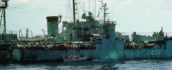 Crew from the U.S. destroyer escort Kirk reach a South Vietnamese navy ship overflowing with refugees near Con Son Island on May 1, 1975. (Photo courtesy of Jim Bongaard)