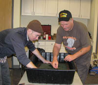 Co-director and co-founder of the Combat Paper Project, Drew Cameron (left), helps Vietnam vet Dan O'Leary create a sheet of paper. (Photo courtesy of the New Jersey Vietnam Veterans' Memorial)